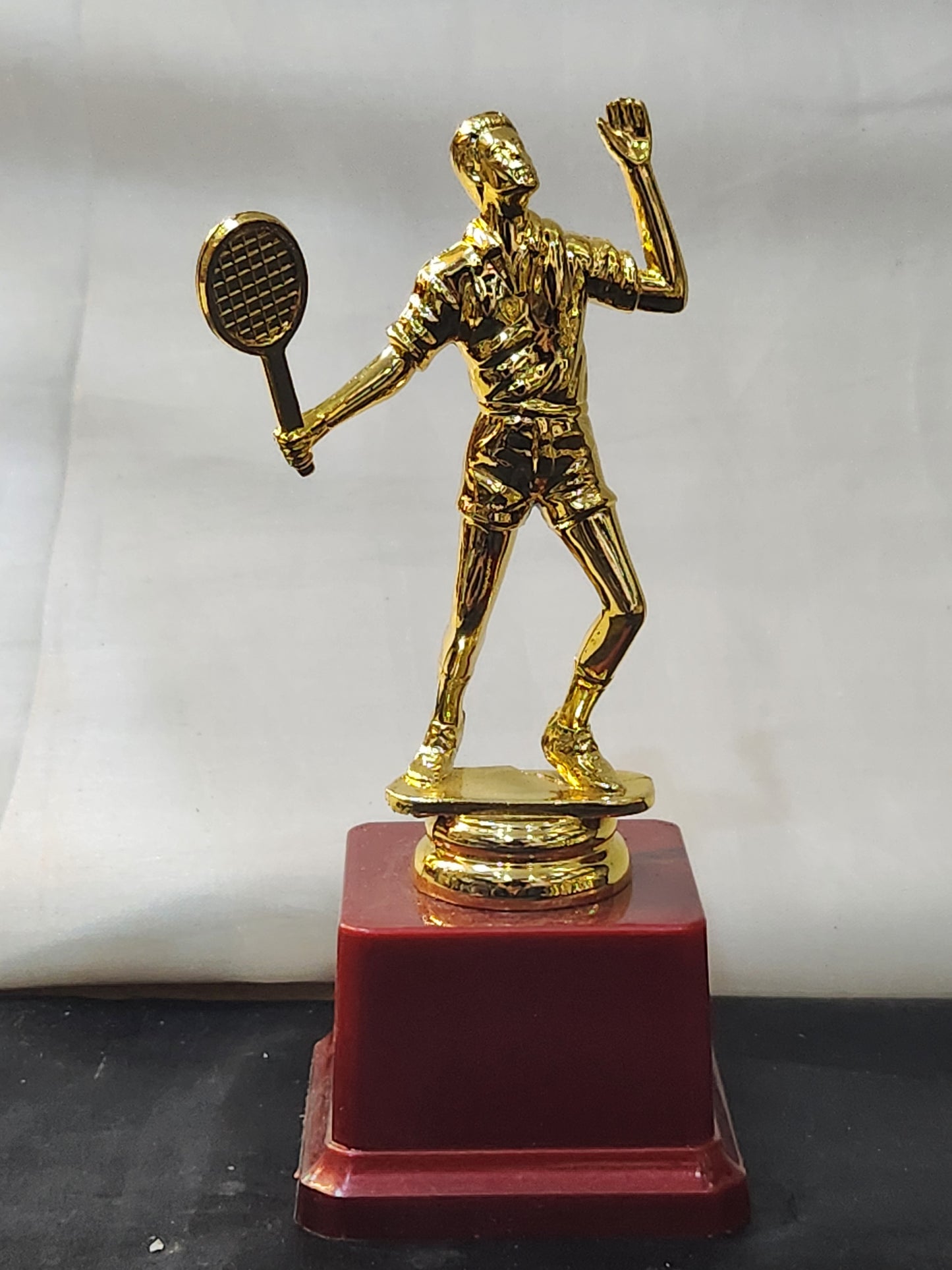 Badminton trophy with a golden finish.